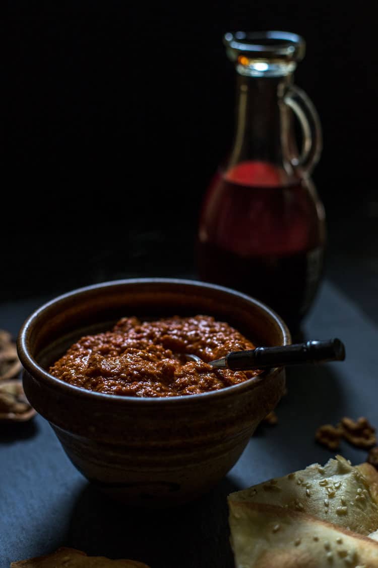 Muhammara red pepper and walnut dip, pictured with a bottle of pomegranate molasses. Vegan and gluten free. 