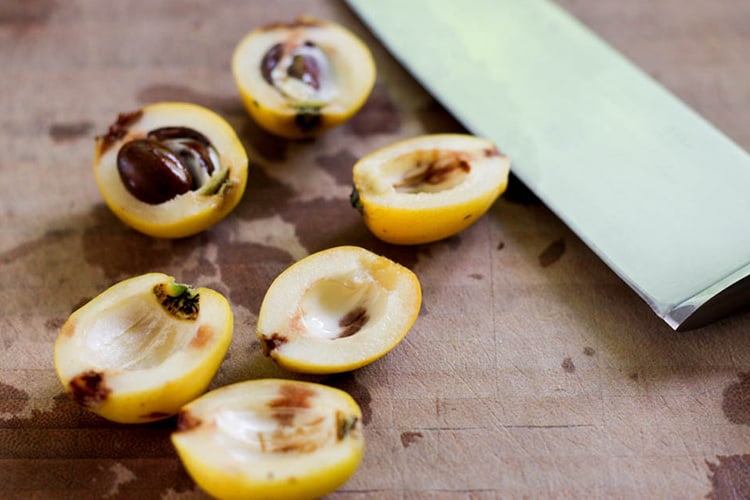 Loquats, cut in half to remove their pips. 