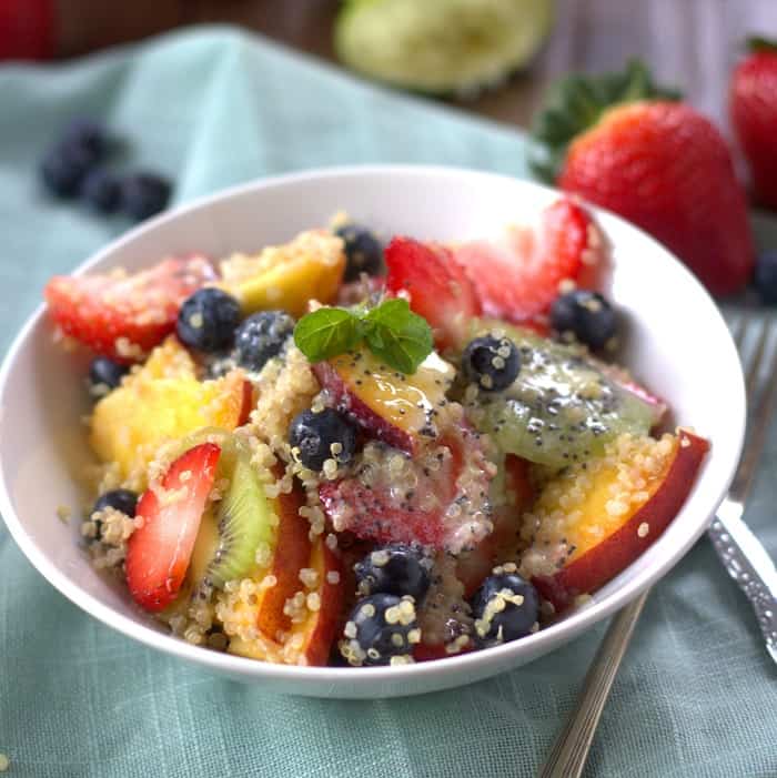 Summer fruit and quinoa salad with coconut ginger lime poppy seed dressing