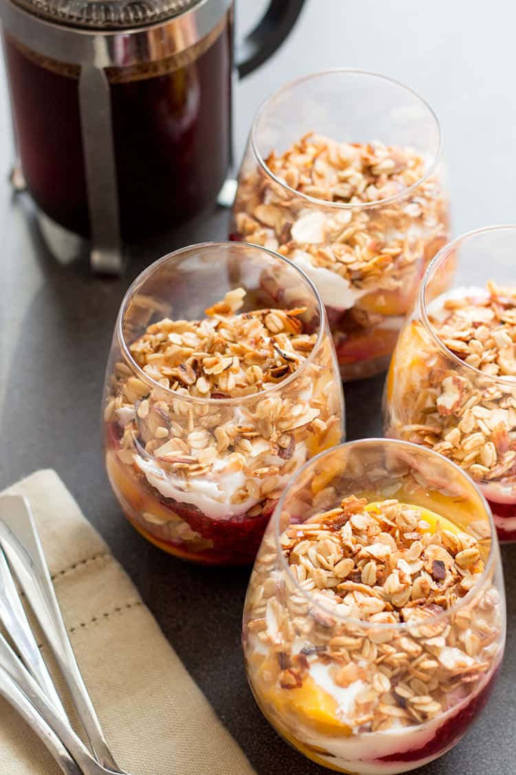 Peach melba breakfast trifle: peaches, raspberry chia jam, coconut yoghurt and granola layered with cake.