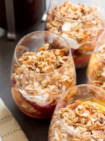 Peach melba breakfast trifle: peaches, raspberry chia jam, coconut yoghurt and granola layered with cake.