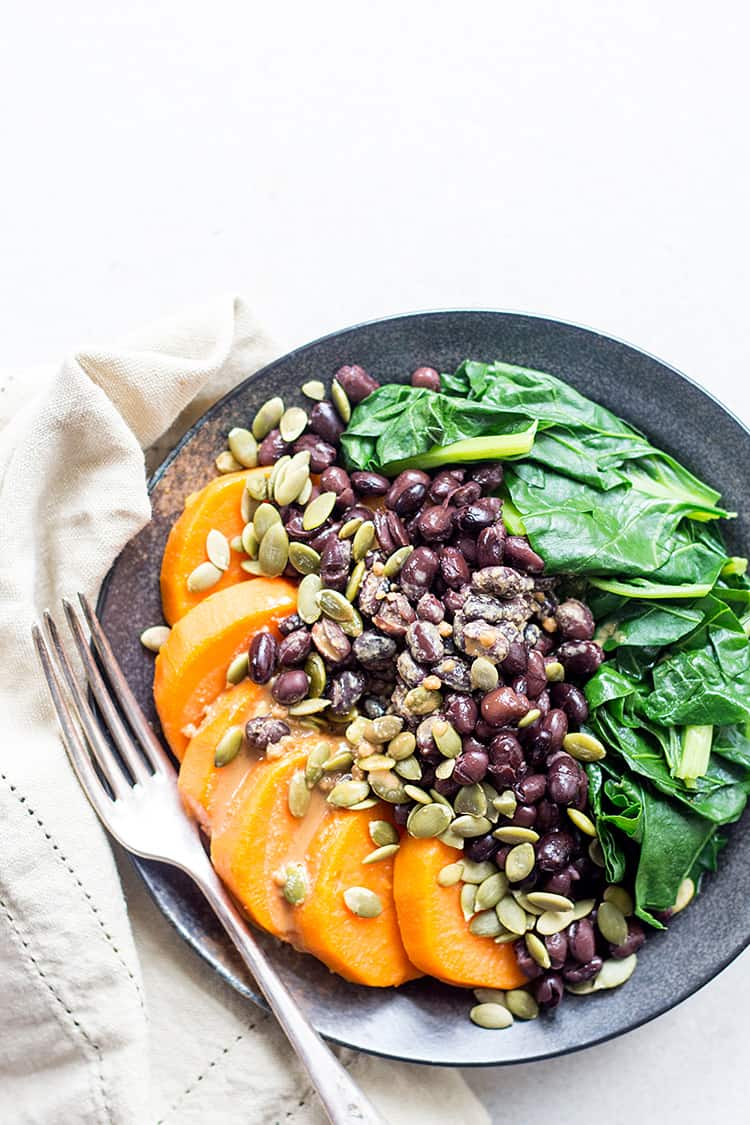 Black bean, sweet potato and spinach protein bowl with tahini and tamari dressing (vegan and gluten free). 