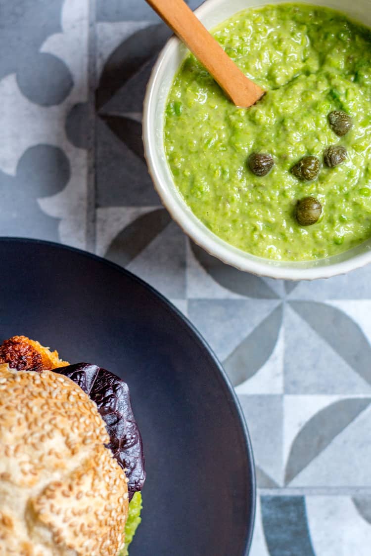 Crispy tofu burger with green pea and caper mayo (vegan). 