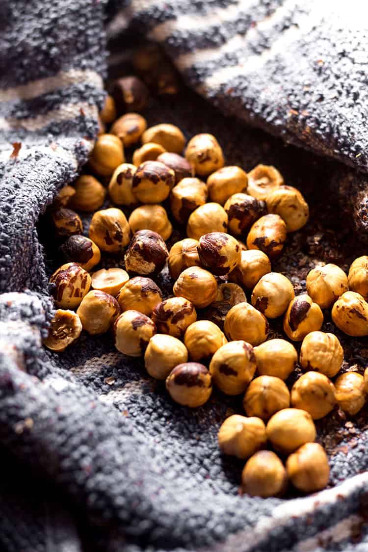 Toasted hazelnuts, skins removed in a clean tea towel. 