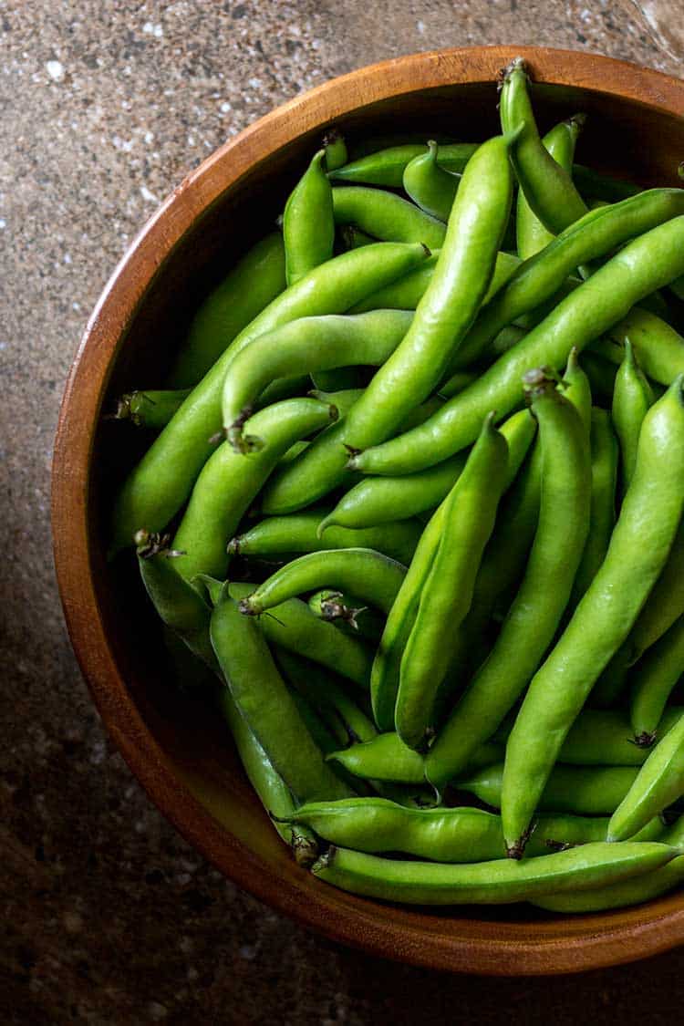 Fresh broad beans, ready to be podded. 