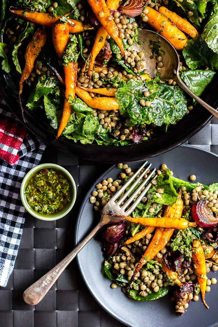 Overhead shot of lentil salad with roast baby carrots and red onions, dressed with chimichurri sauce (vegan and gluten free).