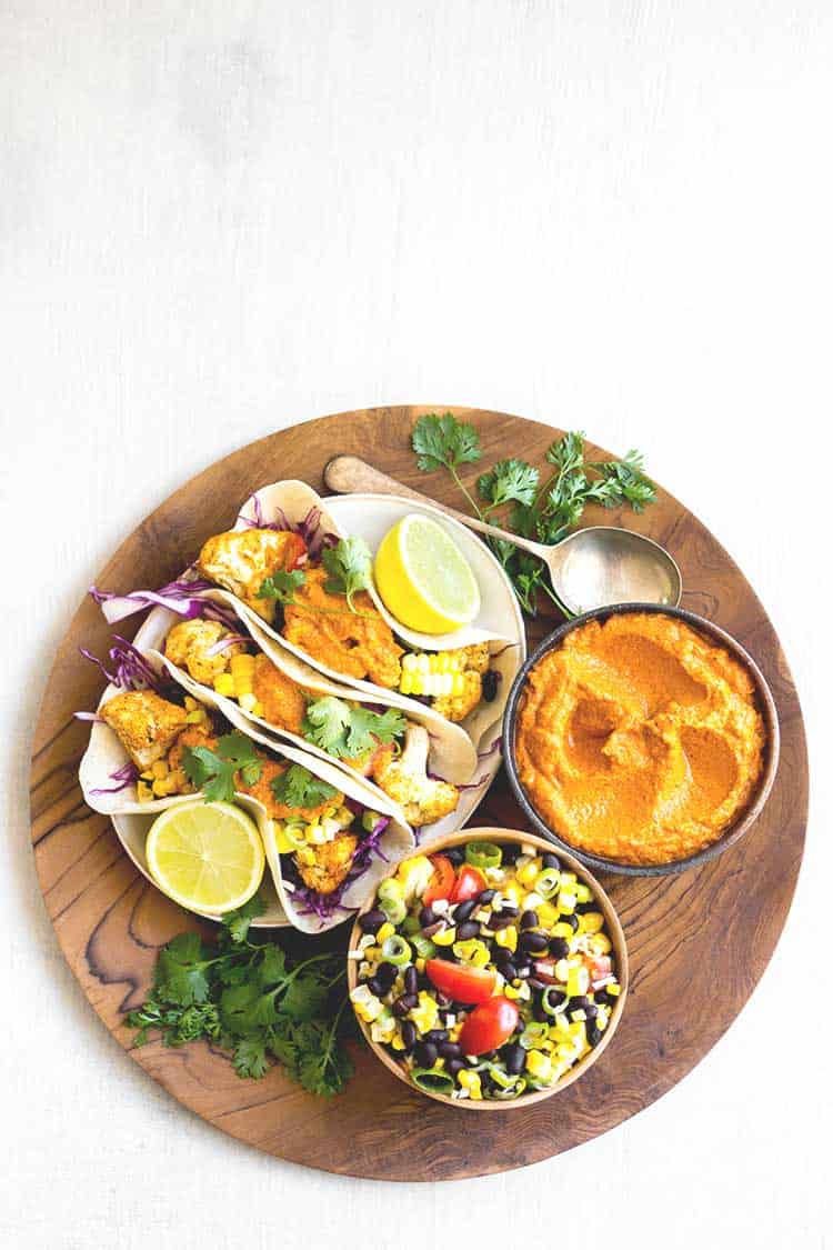 Overhead view of cauliflower tacos with smoky almond chipotle salsa (vegan and gluten free). 