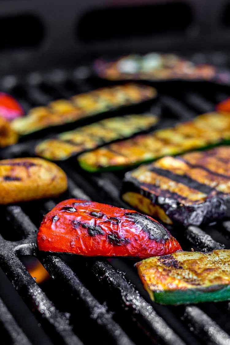 Eggplant, courgette and capsicum being cooked on the barbecue grill. 