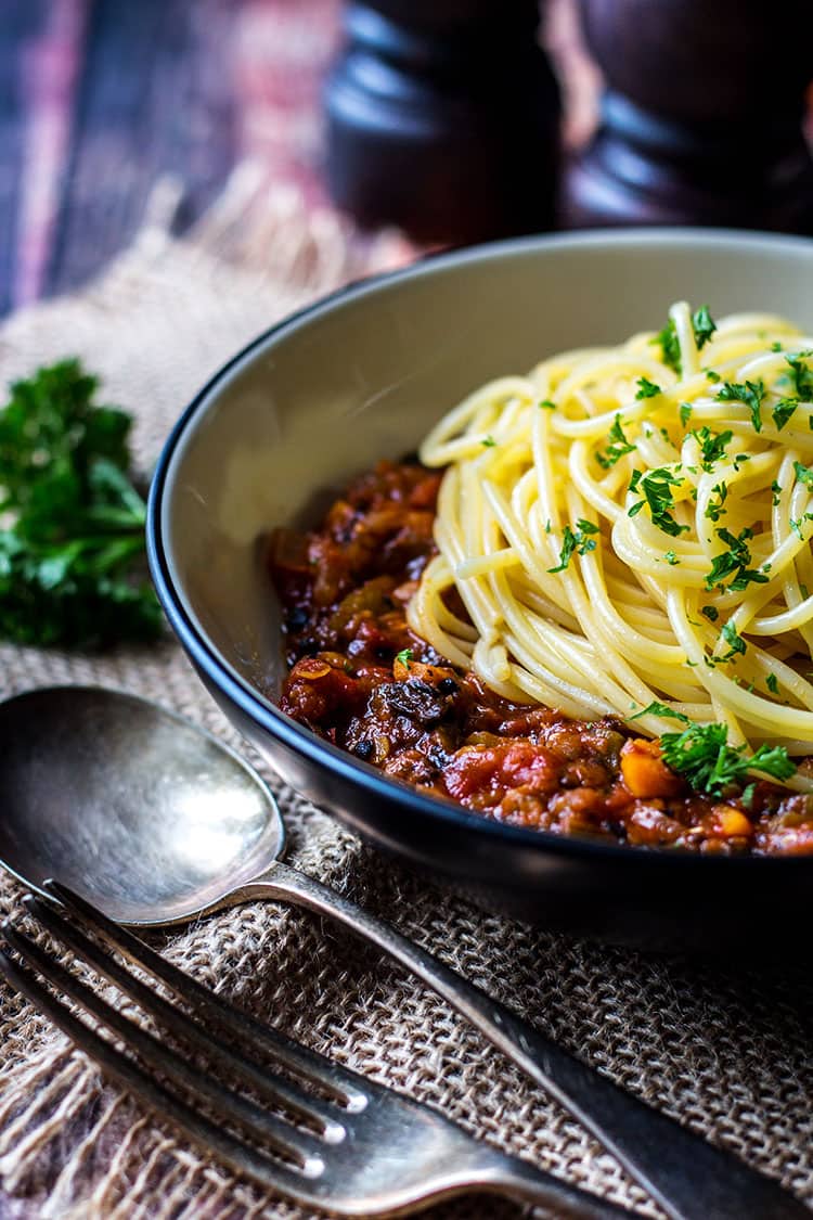 Side view of mushroom and lentil vegan spaghetti bolognese, ready to eat. 