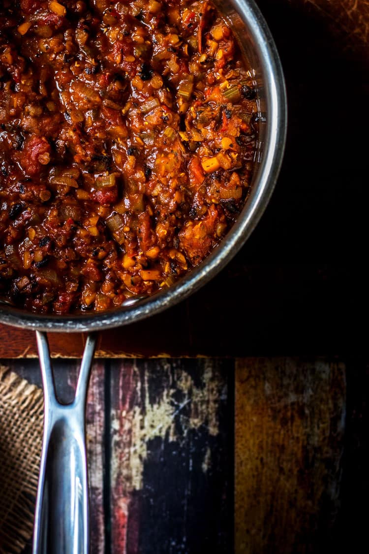 Overhead photo of a saucepan full of mushroom and lentil vegan bolognese sauce. 