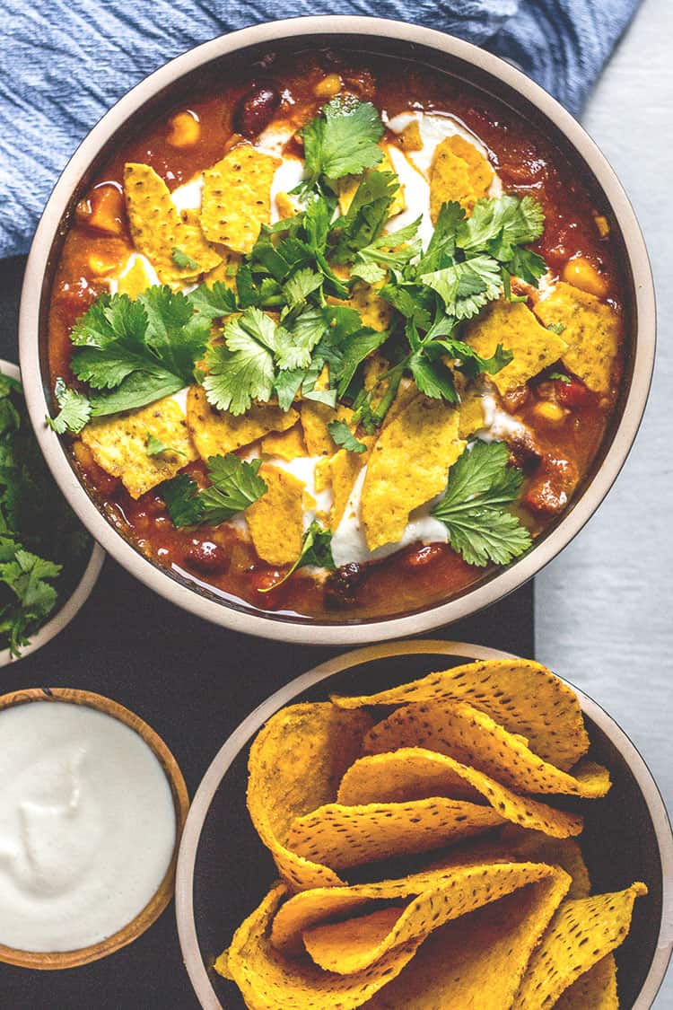 Black bean and corn nacho soup - a Mexican inspired soup topped with corn chips and lime cashew cream. (Vegan and gluten free). 