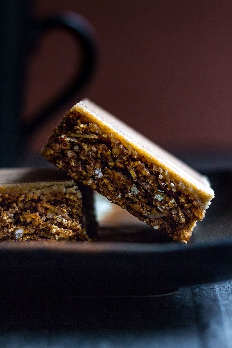Coffee granola slice (gluten free and vegan), served with a cup of coffee.