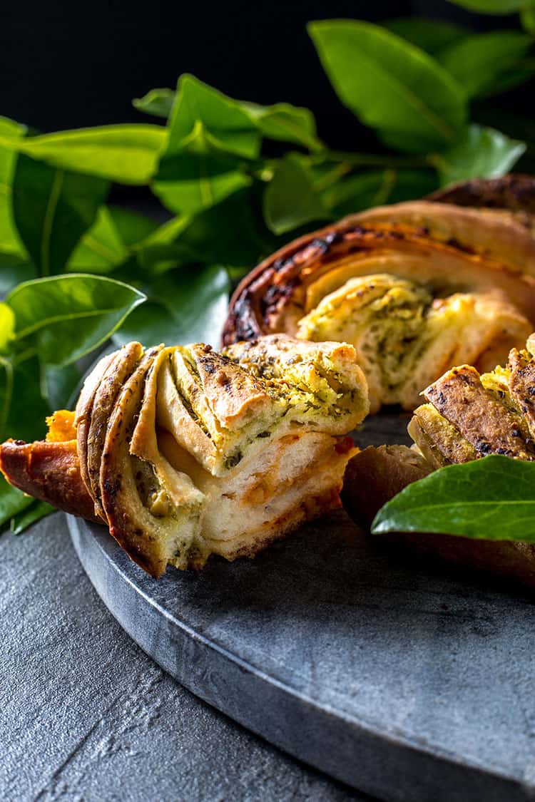 Christmas bread wreath with red and green pesto, cut and ready to serve. Vegan. 