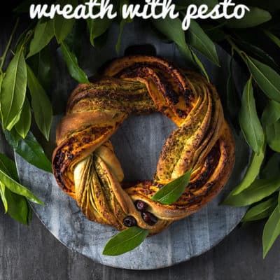 This festive Christmas bread wreath with red and green pestos is satisfying to make and a beautiful addition to any holiday table. Vegan.