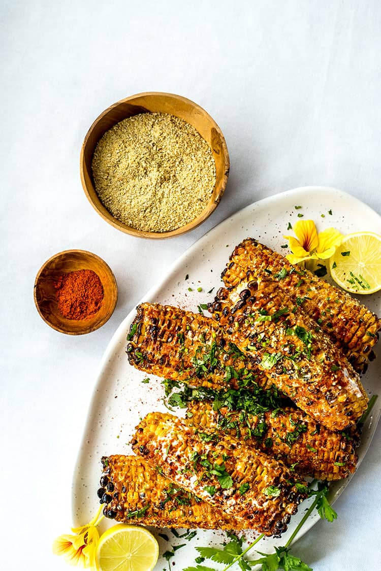 Grilled Mexican sweet corn, with spice mix and vegan parmesan sprinkle. 