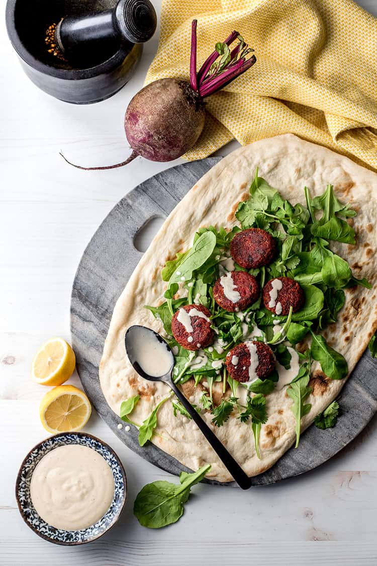 Beetroot falafel, served with flat bread, salad greens and a simple tahini sauce. 