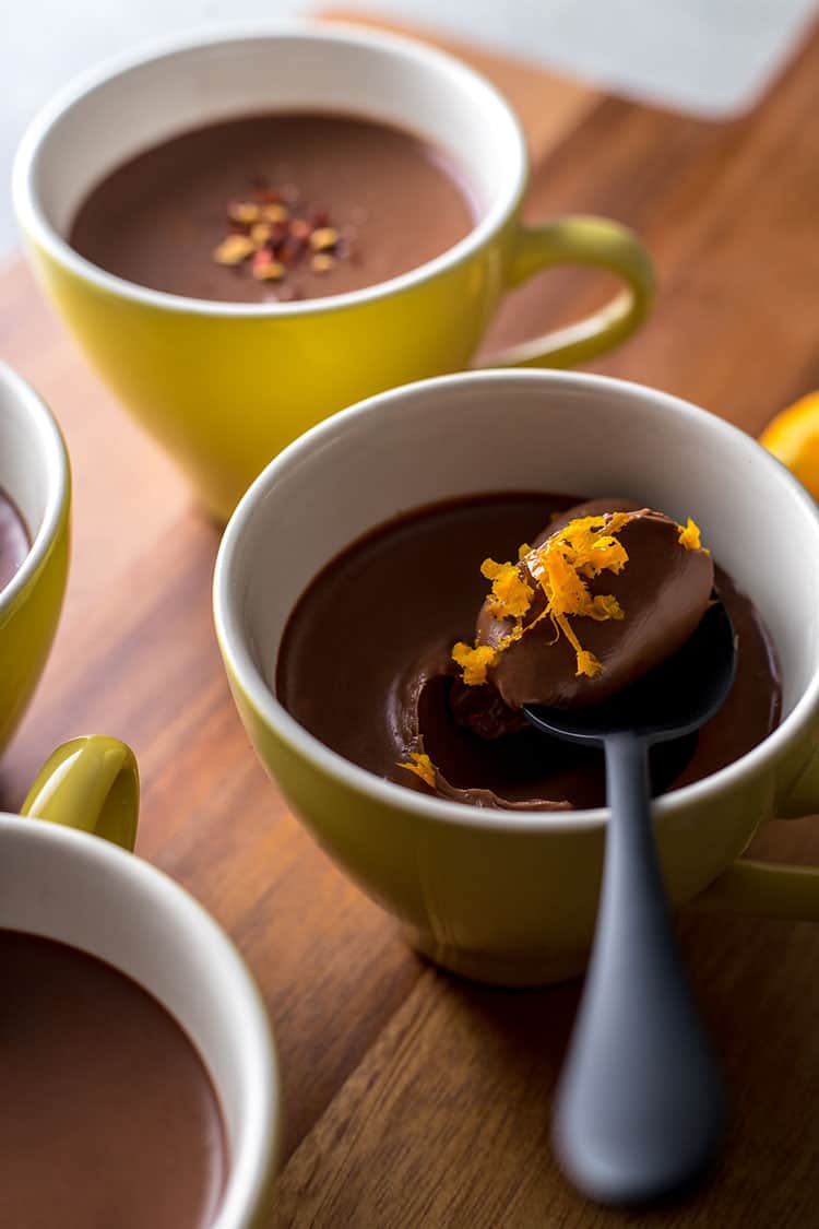 Vegan dark chocolate pots, with a spoonful ready to eat.