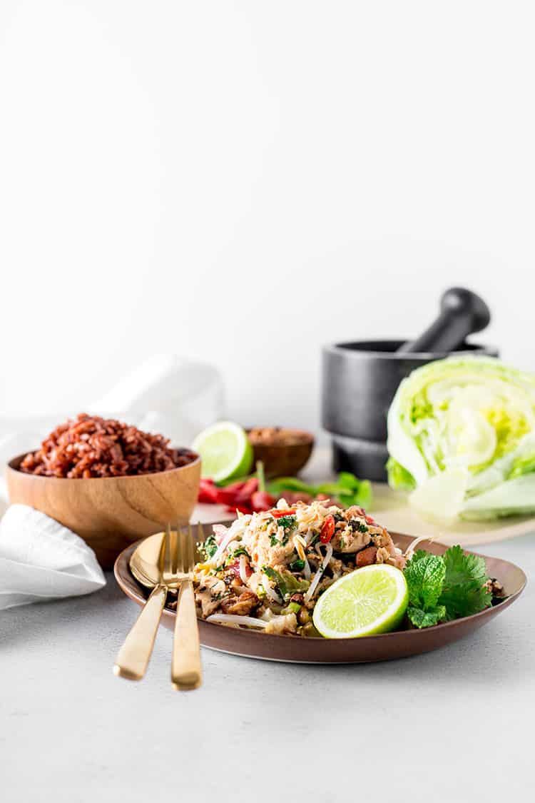 Cauliflower, peanut and tofu larb pictured with red rice, iceburg lettuce and limes. 