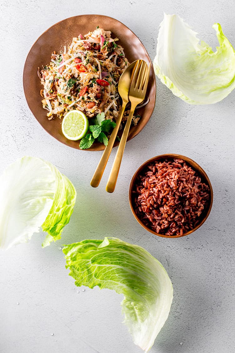 Cauliflower, peanut and tofu larb served with red rice and iceburg lettuce leaves (vegan and gluten free). 