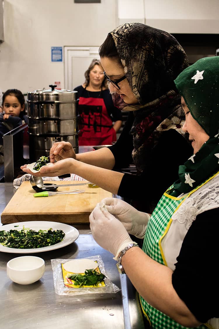 The Home Kitchen team demonstrating how to make ashak - Afghan vegetable dumplings, at a cooking class. 