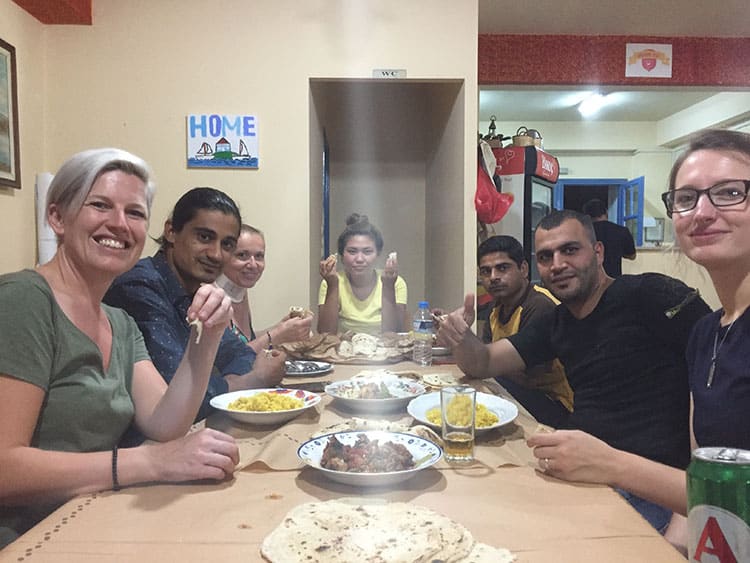 Tania and Katerina sharing a meal with the volunteers at Home For All. 