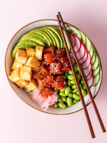 A bowl with edamame beans, sliced radish, cucumber and avocado, fried tofu and marinated watermelon visible.