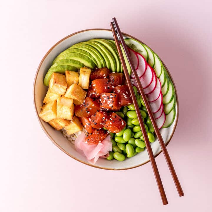 A bowl with edamame beans, sliced radish, cucumber and avocado, fried tofu and marinated watermelon visible.